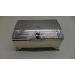 A silver desk box with floral engraving and sprung lid with blue cabouchon type catch, 5.5cm tall