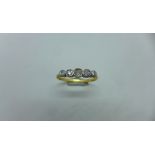 An 18ct gold and platinum 5 stone diamond ring, size O, approx 2.3 grams, hallmarked 18ct. Some