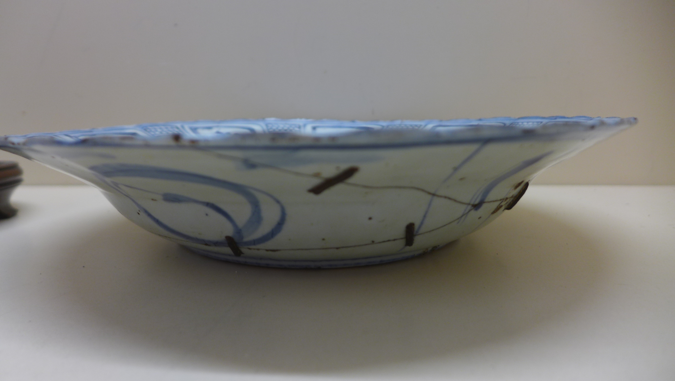 An oriental blue and white fruit and foliate decorated bowl. 5 cm tall x 27.5 cm wide on an - Image 5 of 8