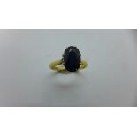 An 18ct hallmarked yellow gold sapphire ring. Sapphire approx 9x6x3.5mm, Size J, approx 2.8gs. In