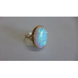 A hallmarked 9ct yellow gold opal ring, size R, approx 3.3 grams, in good condition