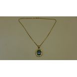 A reversible black opal and diamond pendant set in 18ct yellow gold on an 18ct chain, chain length