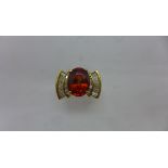 A 14ct Mandarin Garnet and diamond ring, the garnet approx 11 x 8.5 x 5.5mm, ring size O, approx 8.