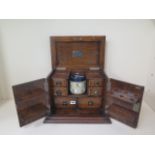 Of railway interest, an oak presentation pipe smokers cabinet from friends at L.M.S dated 1928, 31cm