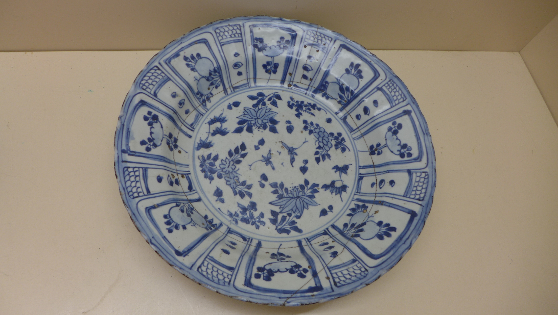An oriental blue and white fruit and foliate decorated bowl. 5 cm tall x 27.5 cm wide on an - Image 6 of 8
