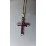 A 14ct yellow gold ruby and diamond crucifix on a 14ct chain - 46cm long - pendant 3cm long -