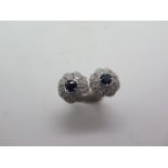 A pair of 18ct white gold sapphire and diamond swirl earrings, 10mm diameter, in good condition,