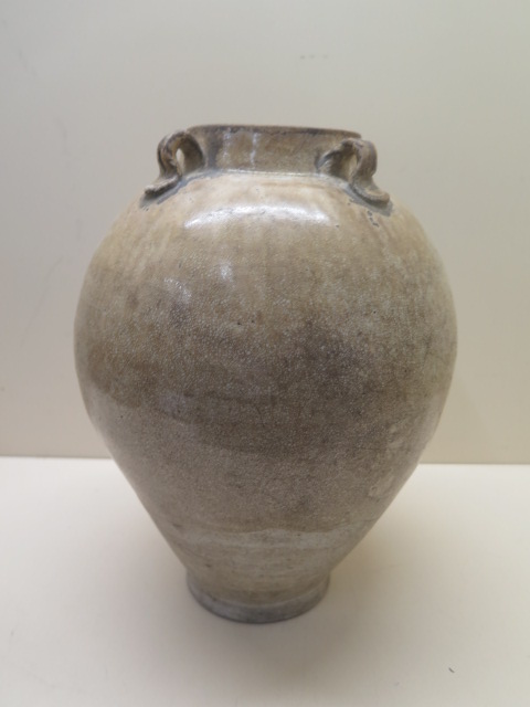 A Chinese Tang Dynasty jar decorated in a light crackle glaze 30 cm tall , condition - old chip to