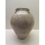A Chinese Tang Dynasty jar decorated in a light crackle glaze 30 cm tall , condition - old chip to