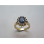A 14ct yellow gold sapphire and diamond ring - the sapphire measures approx 9mm x 7mm x 4mm -