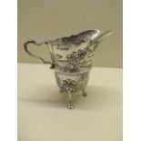 An ornate embossed silver cream jug. 10 cm tall approx 3.4 troy oz. Hallmark Birmingham 1972-73 HIE.