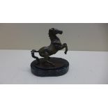 A bronze of a rearing horse on a marble base, 12cm tall, 11cm long in good condition
