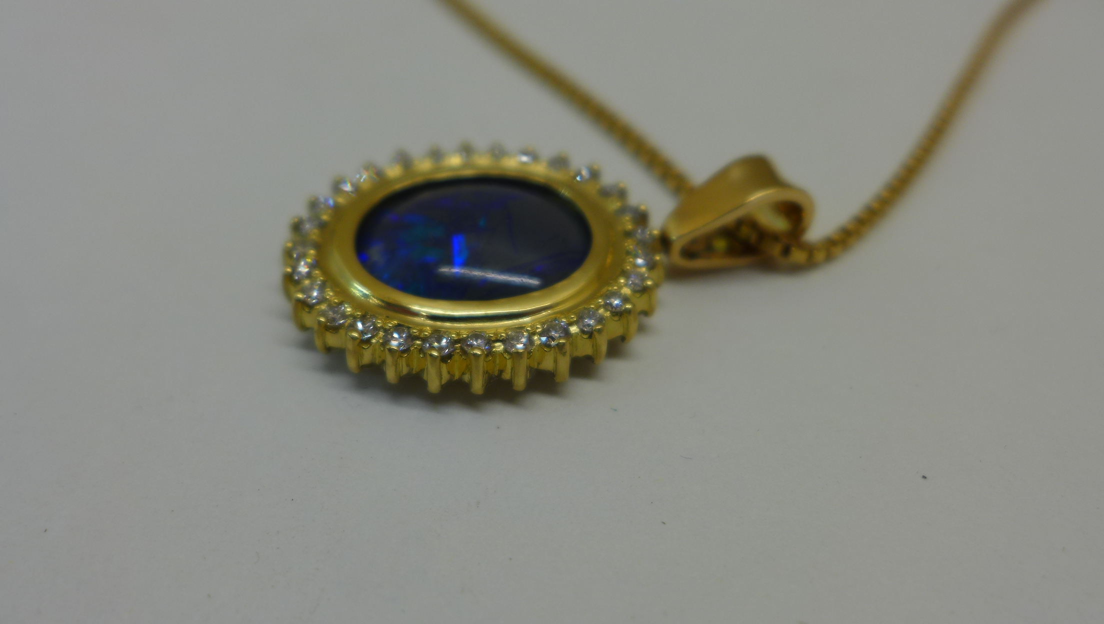 A reversible black opal and diamond pendant set in 18ct yellow gold on an 18ct chain, chain length - Image 4 of 4