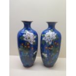 A pair of early 20th century hexagonal cloisonne vases decorated with peony and chrysanthemum on a