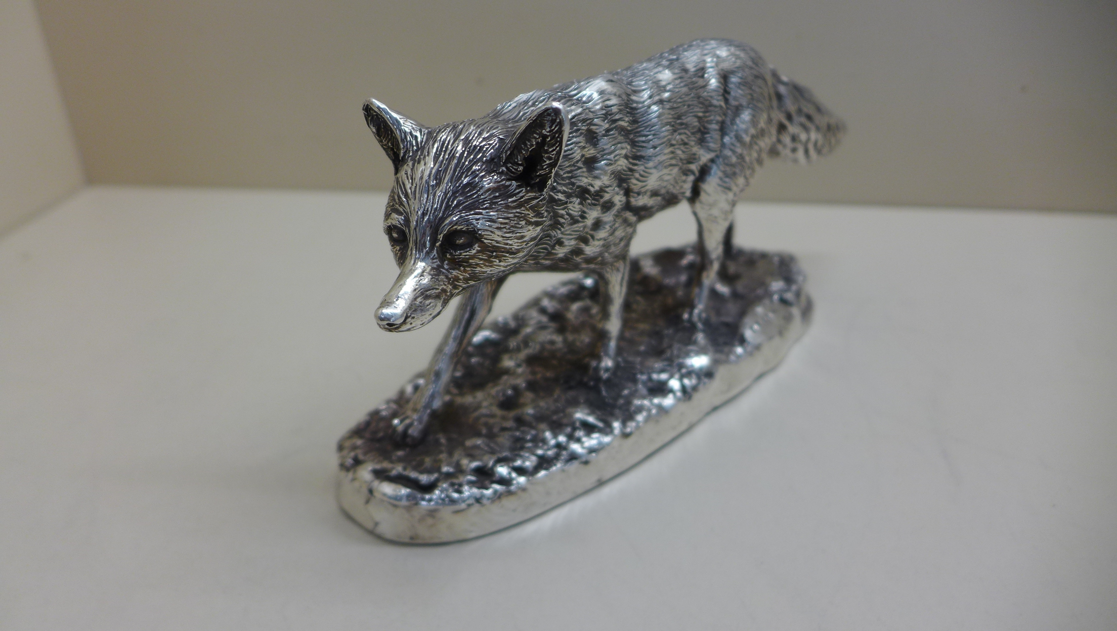 A modern silver resin filled model of a fox by Stiles Silver Sheffield - signed Donaldson. 24cm long