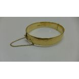 A hallmarked 9ct yellow gold bangle approx 37gs, 5.5 x 6.5cms - in generally good condition