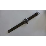 A vintage mid size manual wind pilots watch with black dial, case 3 cm wide, running and hands