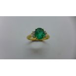 A pretty 18ct yellow gold Emerald and diamond ring. The emerald approx 7.8mm x 6.6mm x 4mm flanked