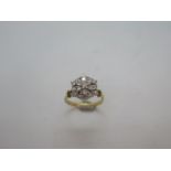 An 18ct yellow gold diamond cluster ring marked 18ct, ring size N, approx 4.3gs. Head measures