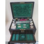 A Victorian coromandel travel box with a fitted interior of plated top bottles manicure etc. In good