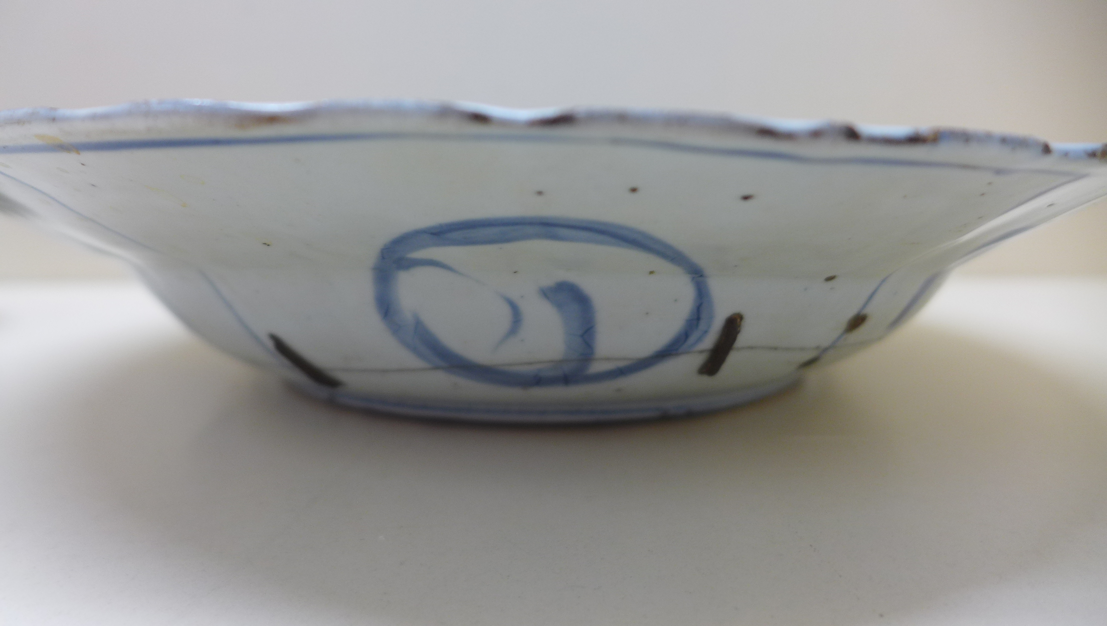 An oriental blue and white fruit and foliate decorated bowl. 5 cm tall x 27.5 cm wide on an - Image 4 of 8