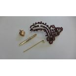 A gilt metal locket, stick pin and pearl brooch. No hallmarks, approx 6.9 grams and a dress brooch