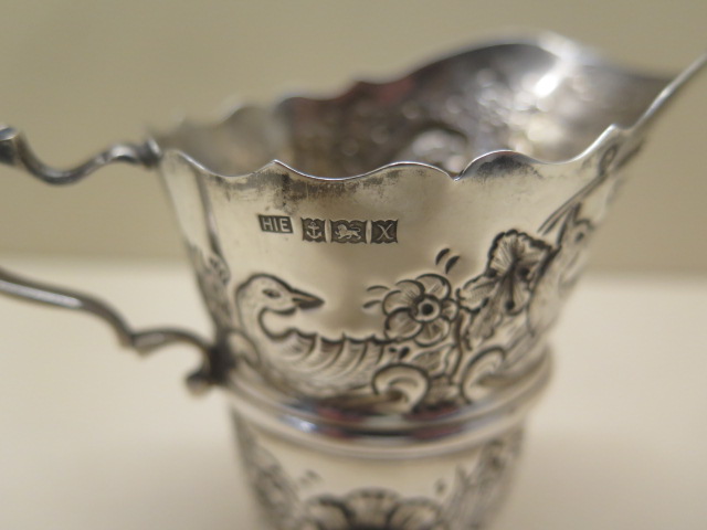 An ornate embossed silver cream jug. 10 cm tall approx 3.4 troy oz. Hallmark Birmingham 1972-73 HIE. - Image 2 of 4