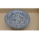 An oriental blue and white fruit and foliate decorated bowl. 5 cm tall x 27.5 cm wide on an