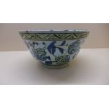 An Iznik bowl decorated in blue and green. 12 cm tall x 22.5 cm diameter with breaks and
