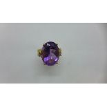 An impressive 18ct yellow gold Amethyst and diamond ring. The amethyst approx 20mm x 15mm x 10mm