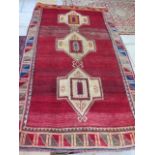 A hand knotted woollen Shiraz rug, 2.04m x 1.20m