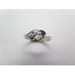 A very pretty 950 platinum diamond and purple sapphire ring, the oval brilliant cut diamond, with