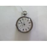 A silver key wind pocket watch, 4.7mm wide, with second dial, running in saleroom, some usage wear