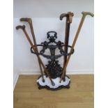 A Victorian cast iron stick stand with 5 sticks, 72cm tall x 46cm wide