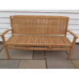 A teak garden bench ex-display as new, 150cm wide