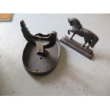 A cast iron foot scraper with cast iron doorstop shaped as a horse