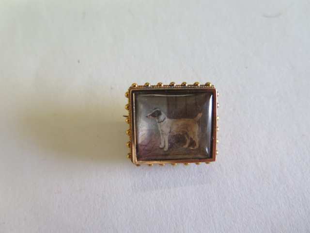 A gilt metal brooch with a hand painted miniature of a dog, 20mm x 18mm, approx 6.4grams in good