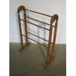 A 20th century polished pine towel rail, 82cm x 62cm