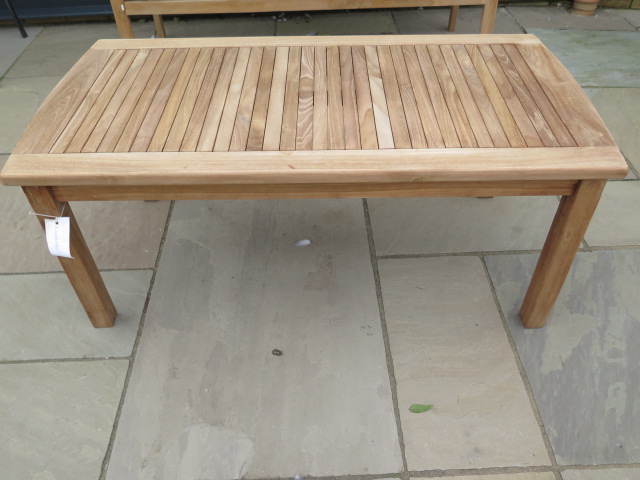 A boxed teak coffee table, new and boxed, 120cm x 60cm