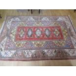 A hand knotted woollen rug with geometric foliate design, 248cm x 163cm, some small wear mainly to