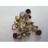 A 9ct gold charm bracelet with a good number of charms and fobs and 2 coin holders, total weight