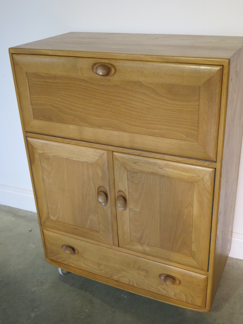 An Ercol blonde elm bureau cabinet with 2 doors and a drawer in good condition, minor scratches to