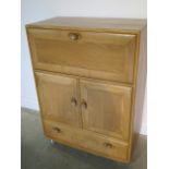 An Ercol blonde elm bureau cabinet with 2 doors and a drawer in good condition, minor scratches to