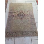 A hand knotted woollen rug with central medallion, overall wear and fading, 215cm x 130cm. Removed