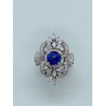 A stunning Art Deco style 18ct white gold sapphire and diamond ring, the central natural sapphire