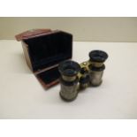 A pair of ornate opera glasses in a faux crocodile case, chip to one lens otherwise reasonably