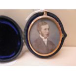 A portrait miniature of a Victorian gentleman in a gilt metal oval frame and velvet lined leather