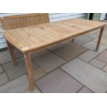 A teak garden table measuring 218cm x 100cm, in sound sturdy condition