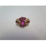 An unhallmarked ruby and diamond cluster ring, size S, approx 5.4grams, tests to approx 18ct, please