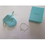 A Tiffany and Co silver bracelet with box and bag in good condition